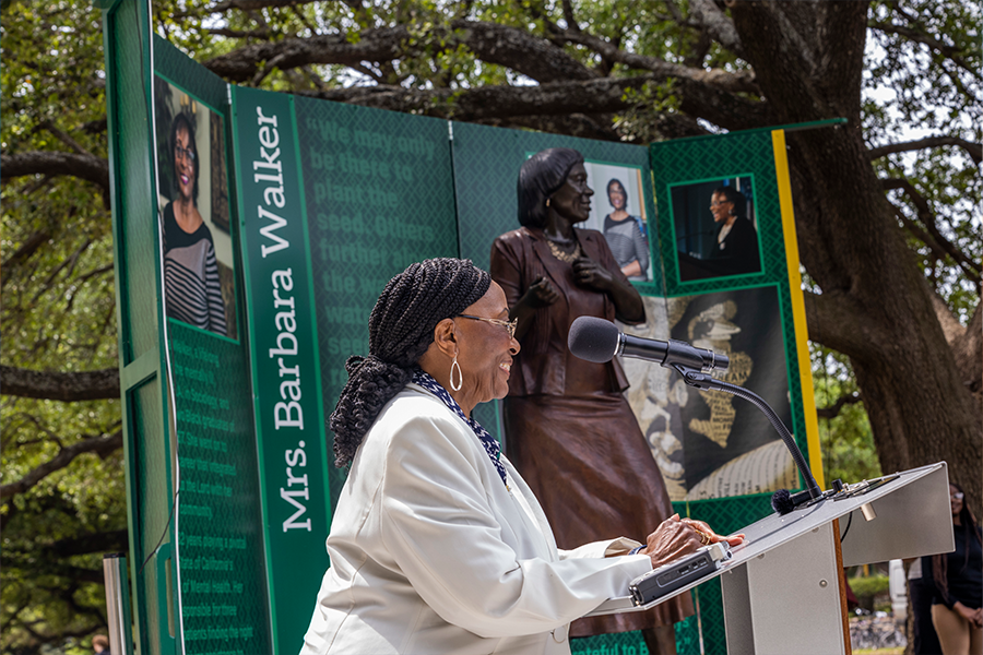 Barbara Walker sharing her story in front of her statue on BU campus