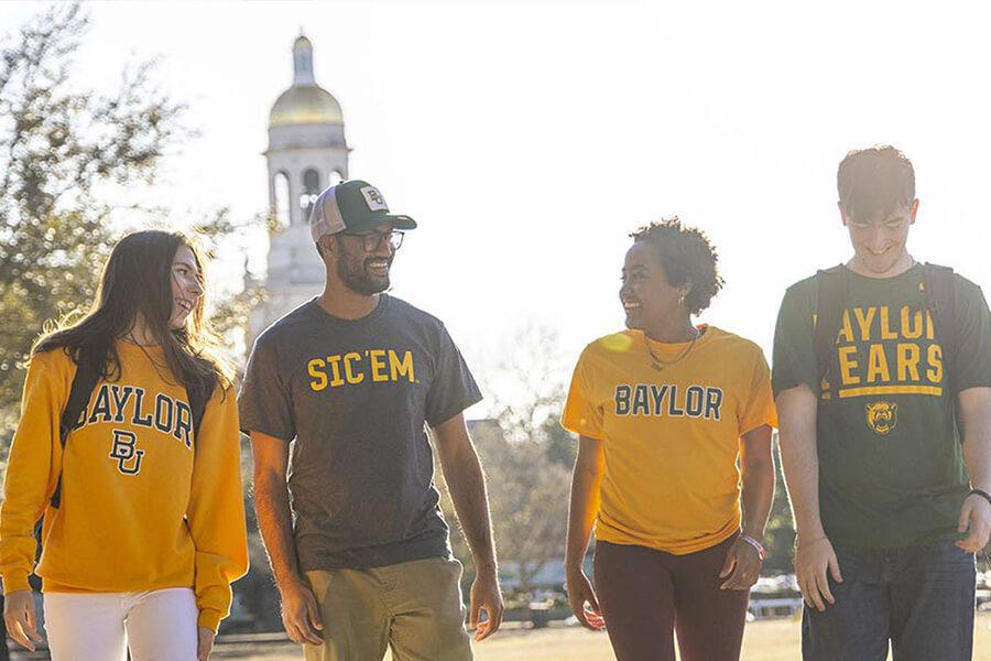 Students walking on campus in Baylor gear